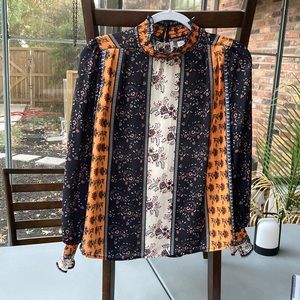 High-neck unique blouse from a small boutique.